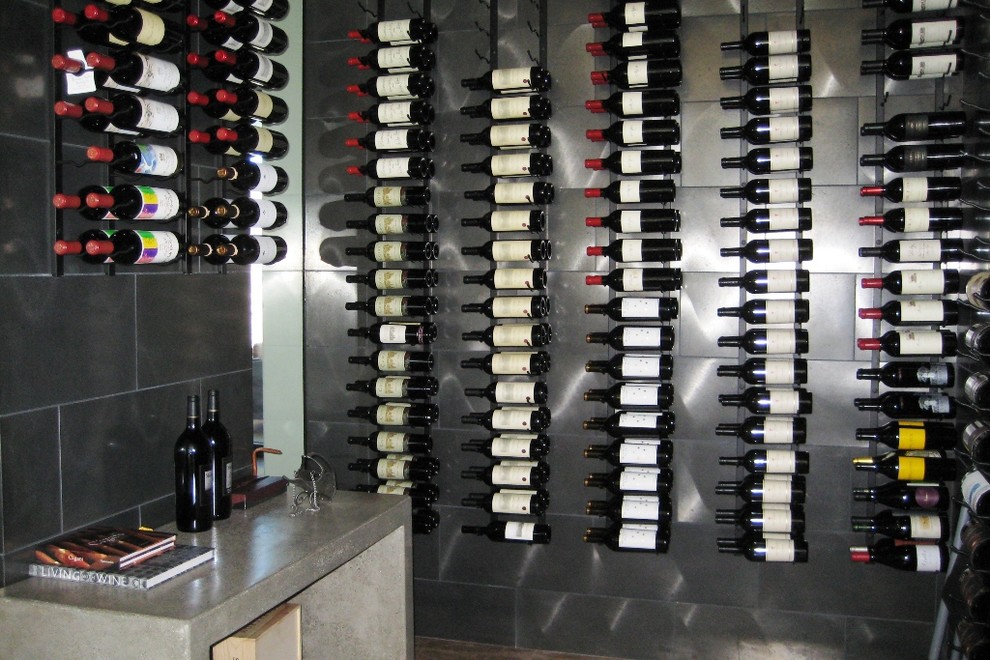 Photo of a large contemporary wine cellar in Los Angeles with ceramic floors and storage racks.
