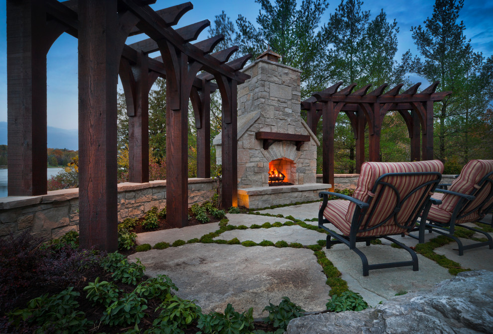 Photo of a country patio in Detroit with a fire feature and a pergola.