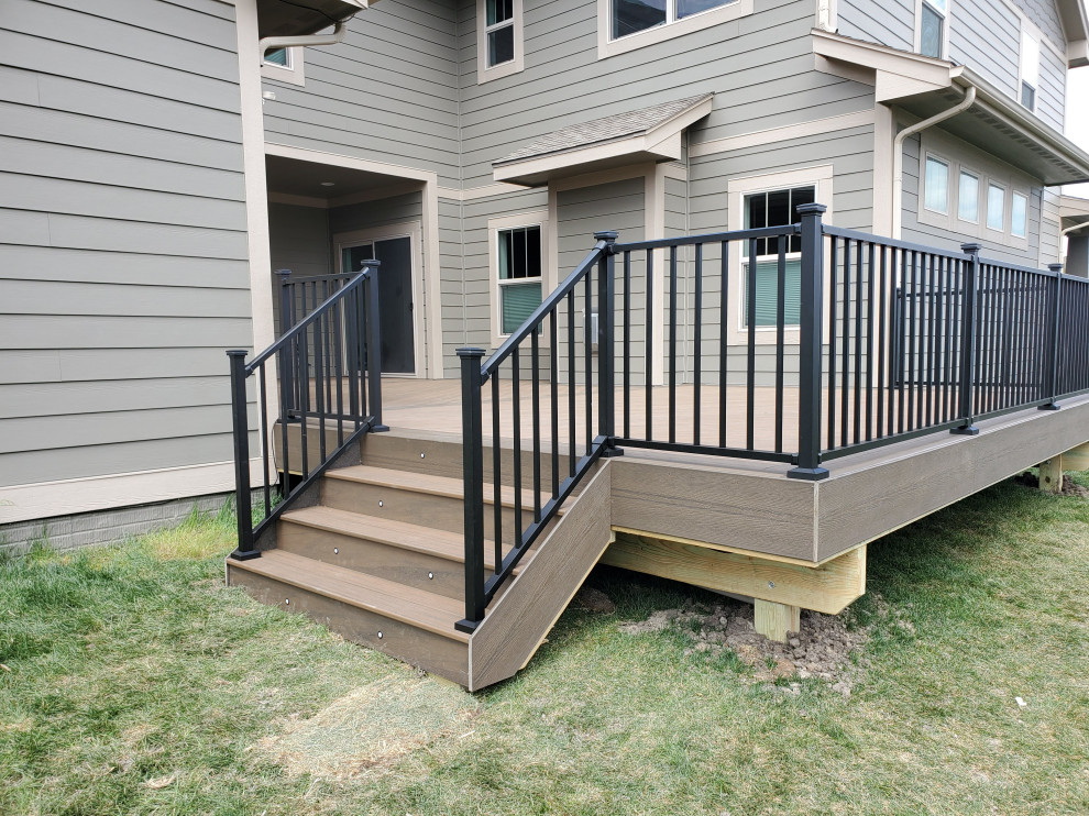 Deck - large courtyard ground level metal railing deck idea with no cover