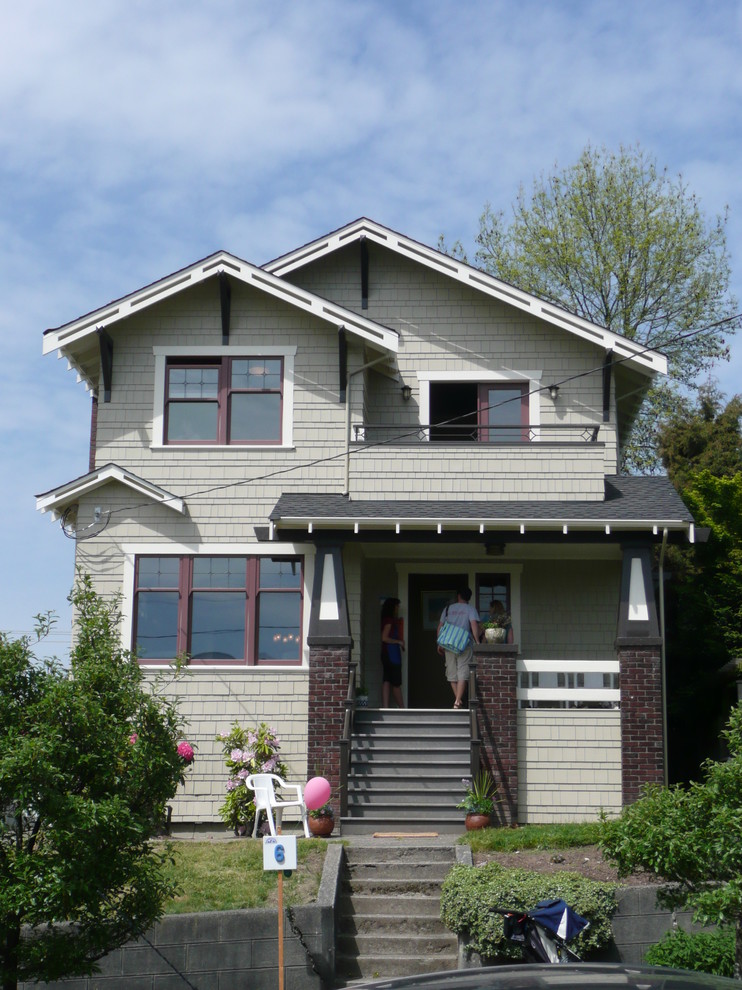 Mid-sized arts and crafts two-storey green house exterior in Seattle with wood siding and a gable roof.