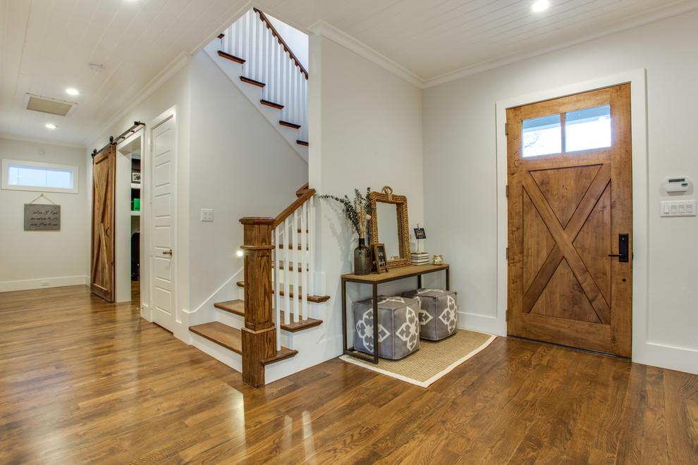 Photo of a mid-sized country front door in Dallas with grey walls, medium hardwood floors, a single front door and a medium wood front door.