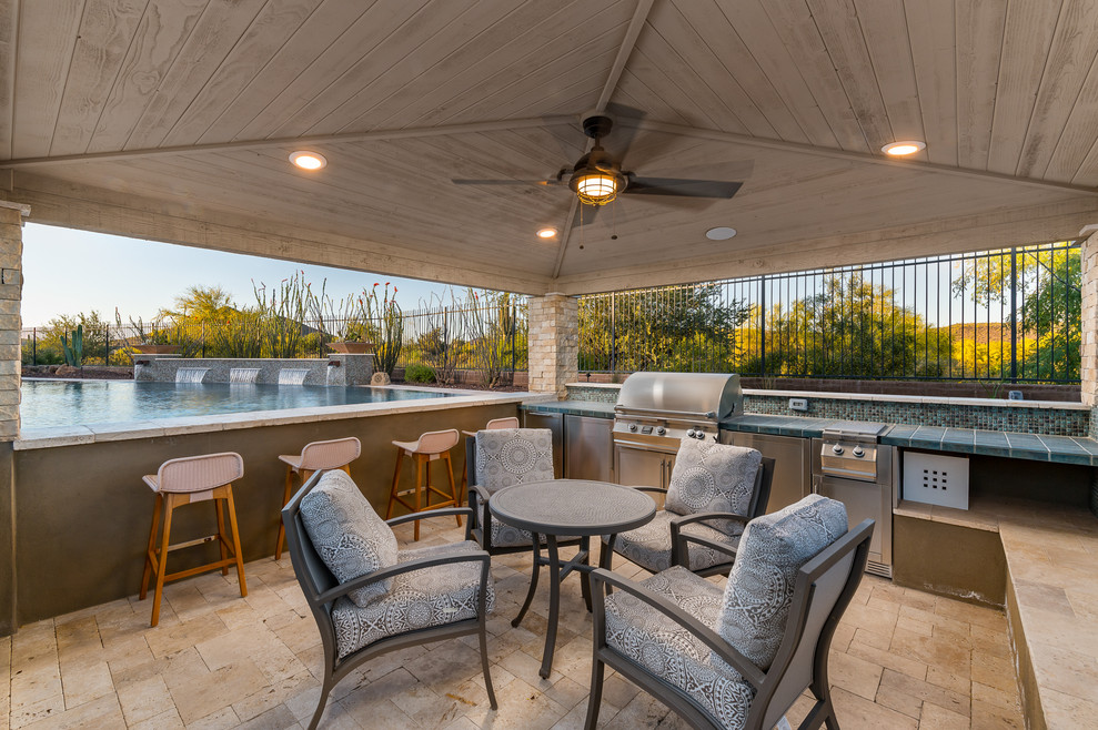 Hot tub - large backyard stone and custom-shaped hot tub idea in Phoenix