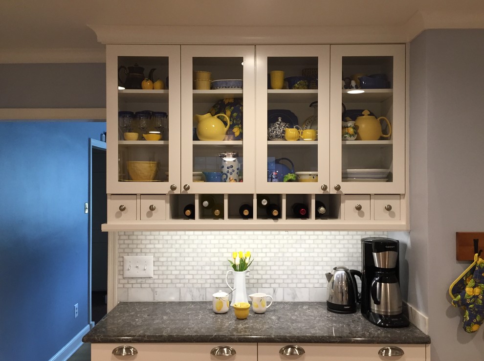 This is an example of a mid-sized traditional galley separate kitchen in Philadelphia with an undermount sink, shaker cabinets, white cabinets, quartz benchtops, white splashback, stone tile splashback, stainless steel appliances, medium hardwood floors and with island.