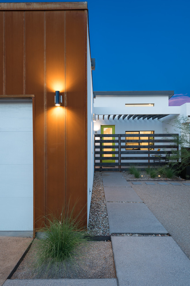 This is an example of an industrial entryway in Phoenix with a single front door and a green front door.