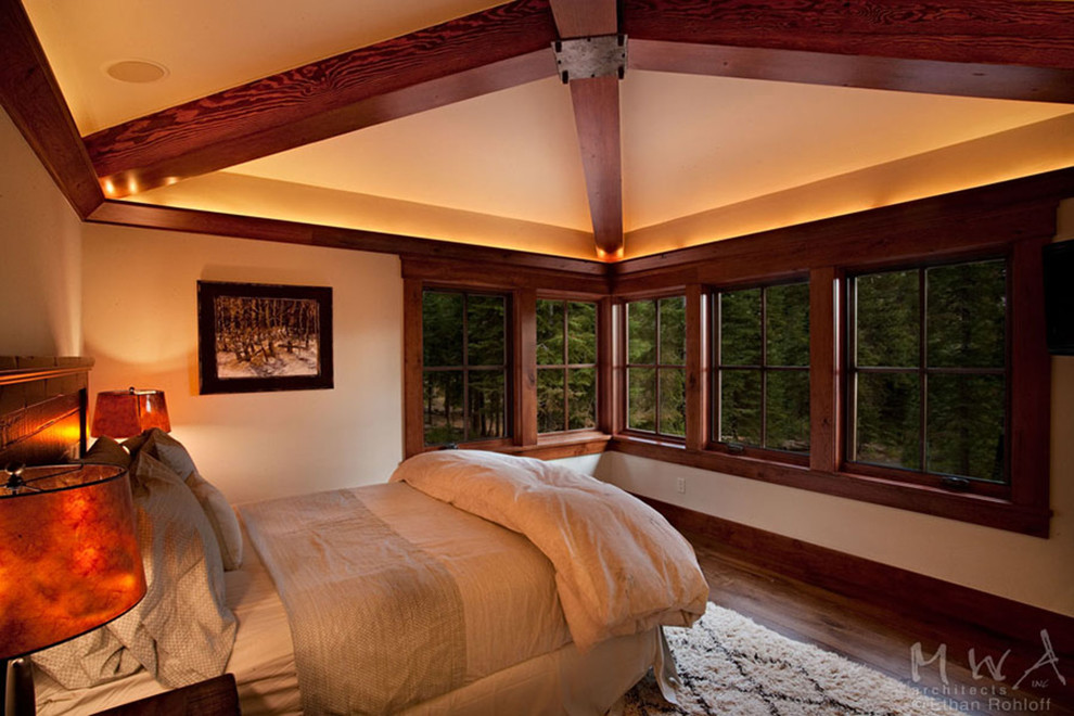 Large arts and crafts guest bedroom in Sacramento with beige walls and dark hardwood floors.