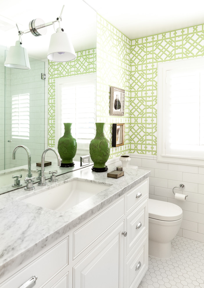 Inspiration for a traditional 3/4 bathroom in Sacramento with raised-panel cabinets, white cabinets, an alcove shower, a one-piece toilet, white tile, ceramic tile, multi-coloured walls, mosaic tile floors, an undermount sink, white floor, a hinged shower door and grey benchtops.