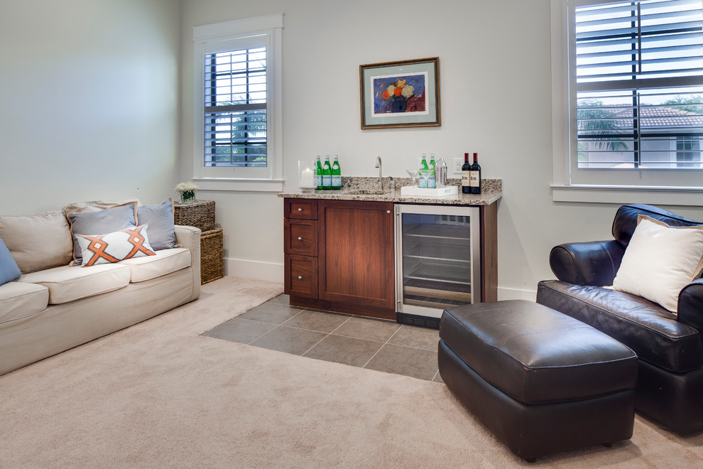 Wet bar - small transitional open concept and single-wall carpeted wet bar idea in Miami with an undermount sink, shaker cabinets, dark wood cabinets and granite countertops