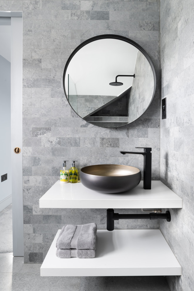 Design ideas for a contemporary bathroom in London with gray tile, a vessel sink, grey floor and white benchtops.