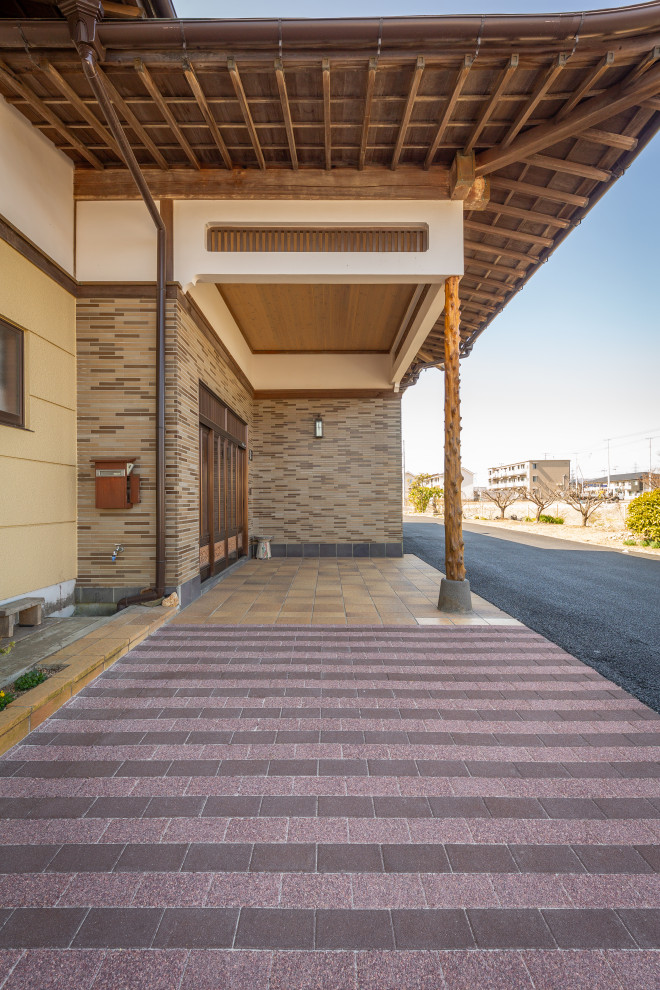 Imagen de acceso privado de estilo zen con portón, exposición total al sol y adoquines de hormigón