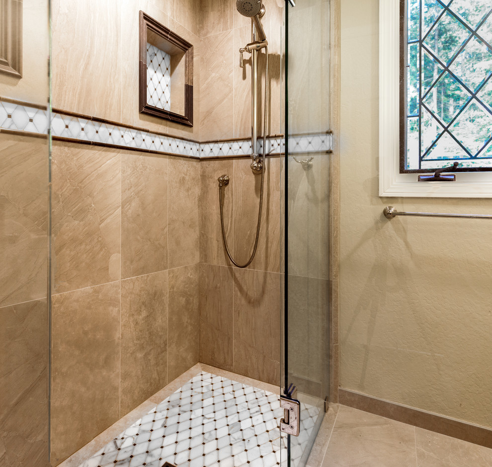 Mid-sized traditional kids bathroom in Other with raised-panel cabinets, dark wood cabinets, a curbless shower, a one-piece toilet, beige tile, porcelain tile, beige walls, marble floors, an undermount sink, granite benchtops, beige floor and a hinged shower door.