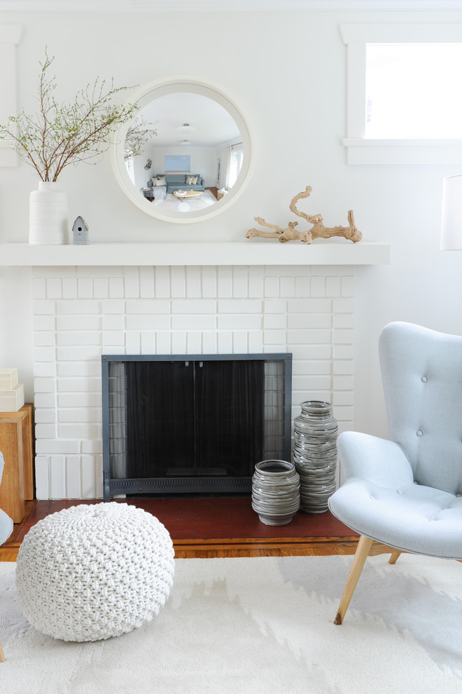Inspiration for a mid-sized transitional formal open concept living room in Vancouver with white walls, medium hardwood floors, a standard fireplace, a brick fireplace surround and no tv.
