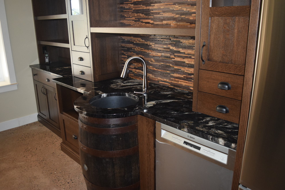 Photo of a mid-sized country single-wall wet bar in Other with an undermount sink, shaker cabinets, dark wood cabinets, granite benchtops, multi-coloured splashback, concrete floors, multi-coloured floor and stone tile splashback.