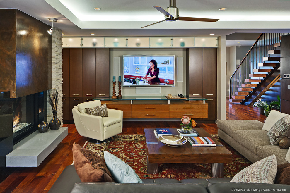 Photo of a contemporary open concept living room in Austin with a two-sided fireplace, a metal fireplace surround and a wall-mounted tv.