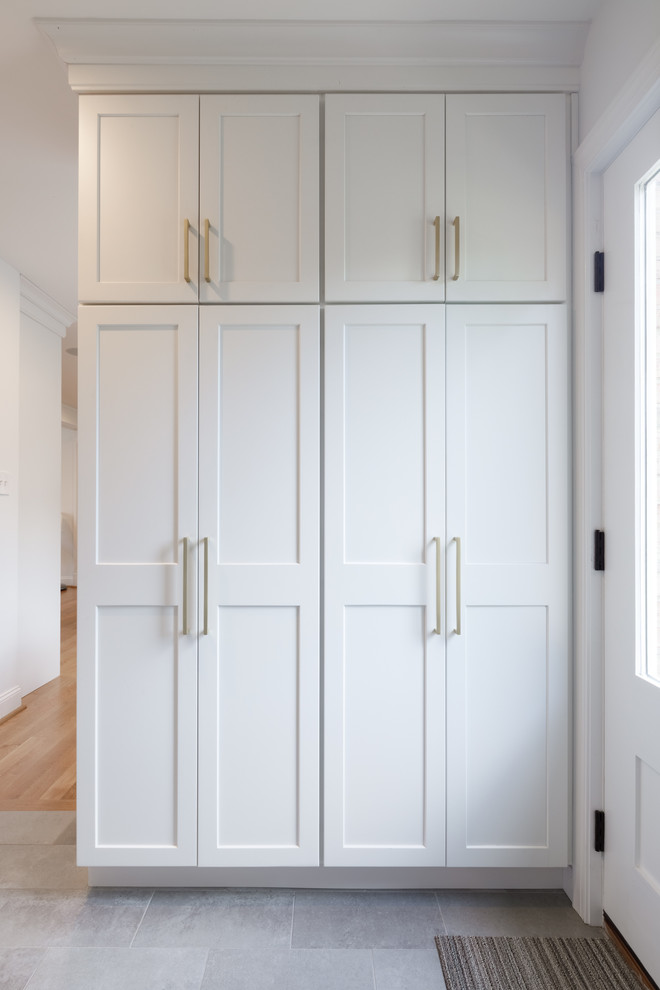 Transitional ceramic tile and beige floor mudroom photo with white walls