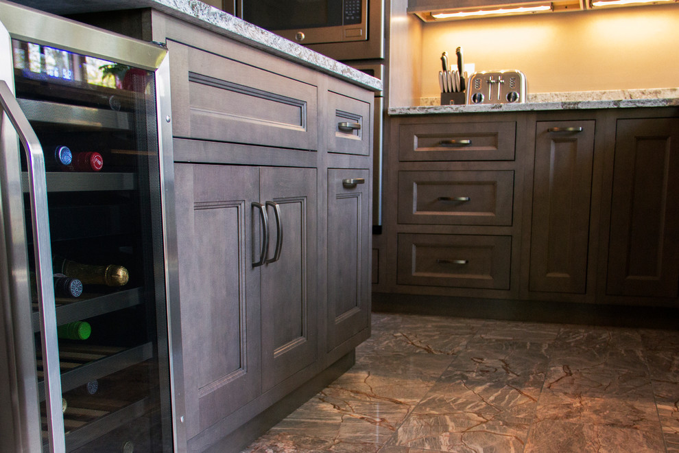 Inspiration for a large transitional u-shaped marble floor eat-in kitchen remodel with an undermount sink, flat-panel cabinets, quartz countertops, stainless steel appliances and an island