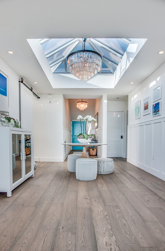 Inspiration for a beach style foyer in Los Angeles with white walls.