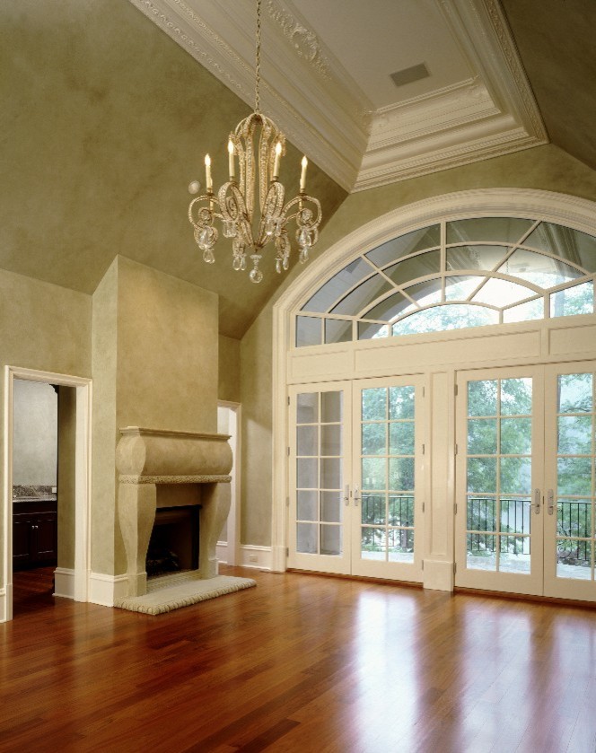 This is an example of a traditional living room in Atlanta with beige walls, medium hardwood floors and a standard fireplace.