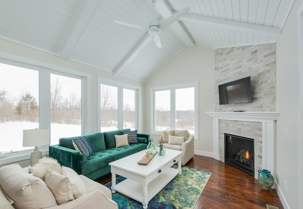 Inspiration for a mid-sized transitional sunroom in Grand Rapids with medium hardwood floors, a corner fireplace, a tile fireplace surround and brown floor.