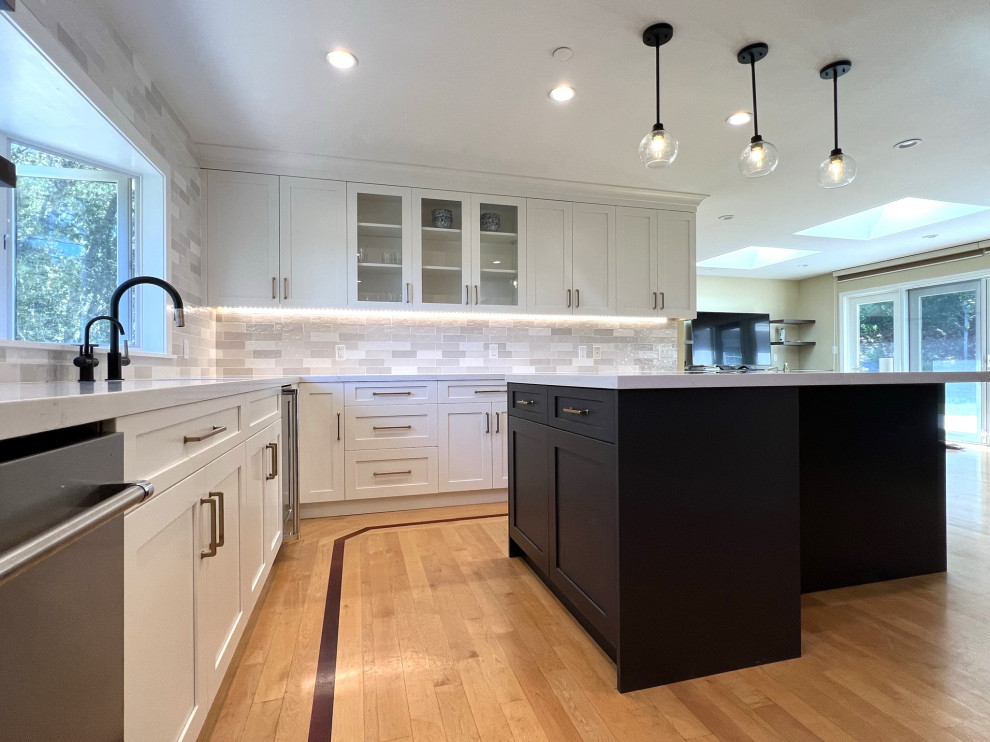 Design ideas for a large transitional u-shaped eat-in kitchen in San Francisco with an undermount sink, shaker cabinets, white cabinets, quartz benchtops, grey splashback, ceramic splashback, stainless steel appliances, medium hardwood floors, with island, yellow floor and white benchtop.