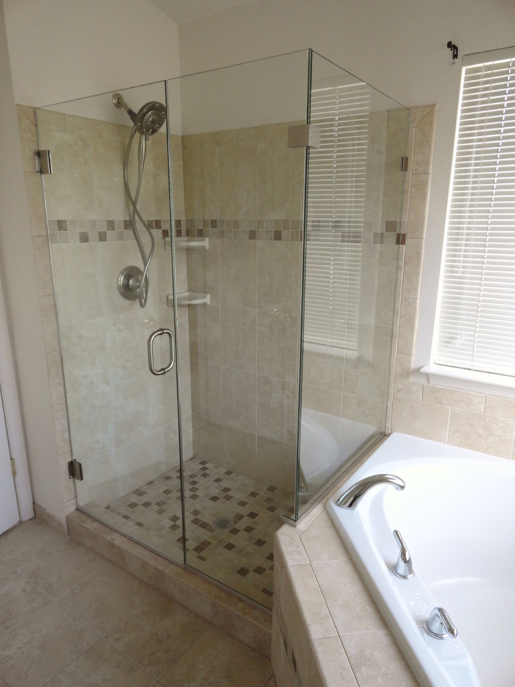 This is an example of a modern bathroom in DC Metro with a corner shower and beige tile.