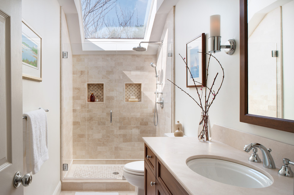 Mid-sized transitional 3/4 bathroom in Philadelphia with medium wood cabinets, white walls, marble floors, marble benchtops, recessed-panel cabinets, an alcove shower, an undermount sink, a hinged shower door and beige floor.