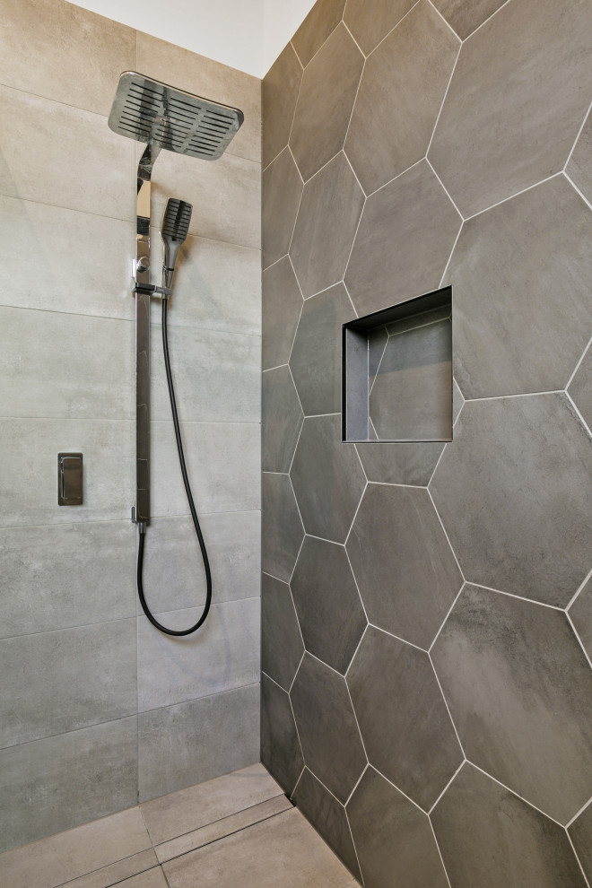 Modern bathroom in Other with gray tile, grey walls, grey floor and beige benchtops.