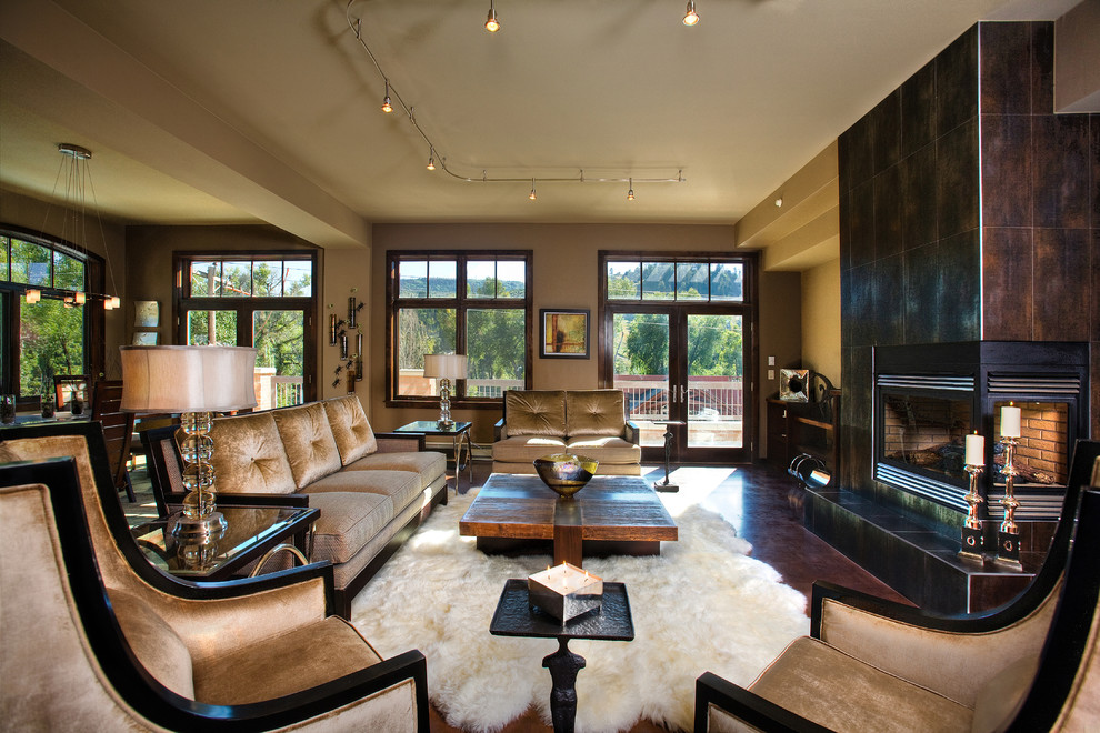 Photo of a contemporary living room in Denver with a metal fireplace surround and dark hardwood floors.