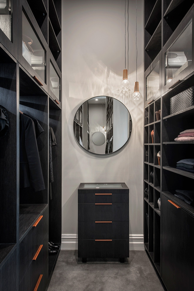 Photo of a contemporary gender-neutral dressing room in Adelaide with open cabinets, black cabinets, carpet and grey floor.