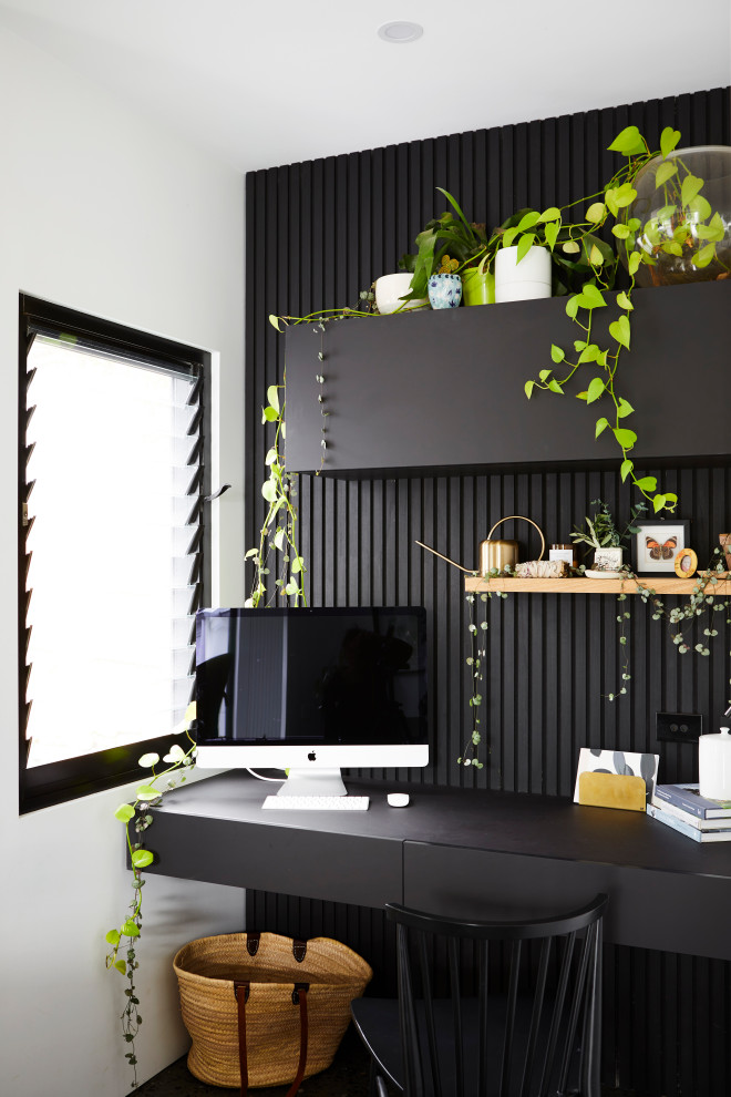 Design ideas for a small contemporary home office in Other with black walls and a built-in desk.