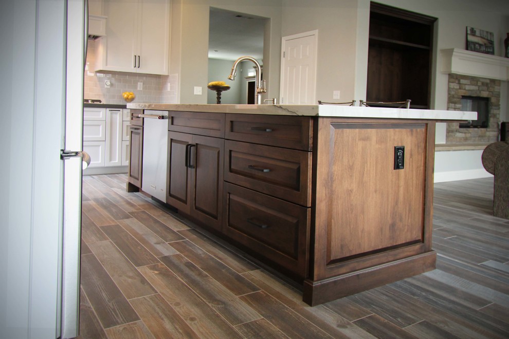 Mid-sized transitional l-shaped porcelain tile open concept kitchen photo in Sacramento with an undermount sink, shaker cabinets, gray cabinets, quartzite countertops, gray backsplash, ceramic backsplash, stainless steel appliances and an island