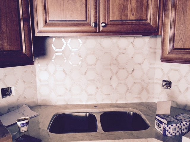 Example of a transitional light wood floor kitchen design in Chicago with quartzite countertops, white backsplash and marble backsplash