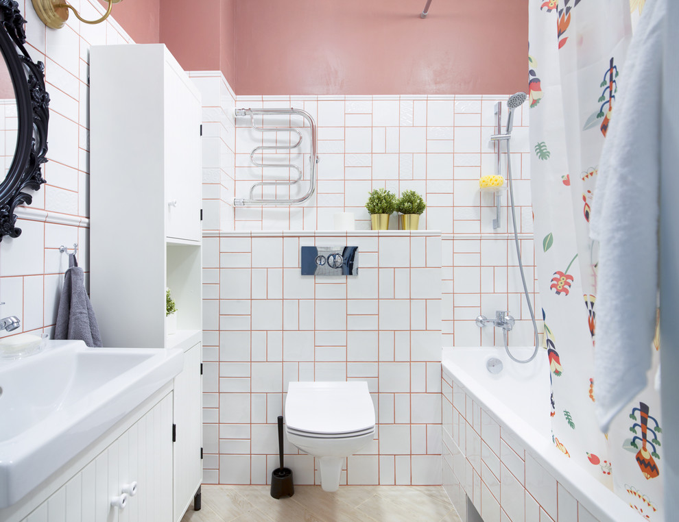 Photo of a small contemporary master bathroom in Novosibirsk with white cabinets, a wall-mount toilet, white tile, ceramic tile, red walls, porcelain floors, beige floor, a shower curtain, flat-panel cabinets, an alcove tub, a shower/bathtub combo and an integrated sink.