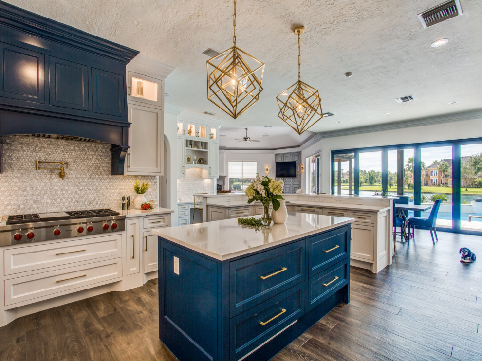 Inspiration for a large transitional kitchen in Houston with an undermount sink, recessed-panel cabinets, blue cabinets, quartz benchtops, white splashback, stainless steel appliances, ceramic floors, with island, brown floor and white benchtop.
