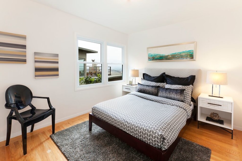Mid-sized contemporary master bedroom in San Francisco with white walls, no fireplace, light hardwood floors and beige floor.