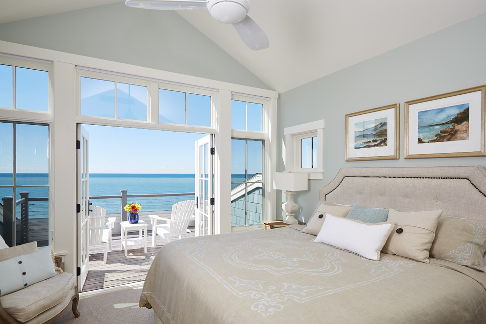 Beach style master bedroom in Grand Rapids with blue walls, carpet, no fireplace and beige floor.