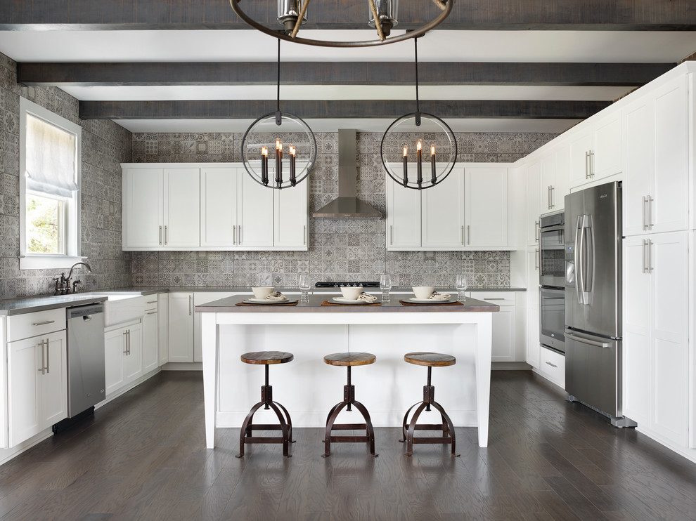 Design ideas for a transitional u-shaped kitchen in Atlanta with a farmhouse sink, shaker cabinets, white cabinets, grey splashback, stainless steel appliances, dark hardwood floors and with island.