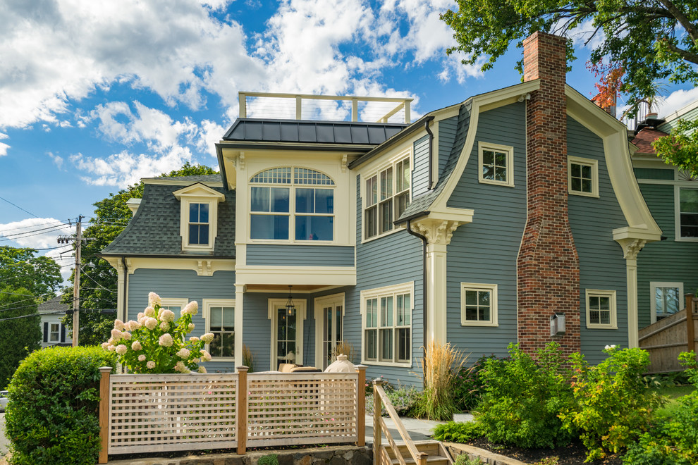 Mid-sized traditional two-storey blue house exterior in Boston with wood siding and a shingle roof.