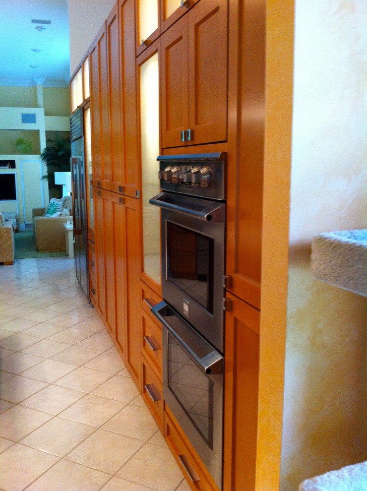 Large transitional u-shaped ceramic tile and beige floor open concept kitchen photo in Miami with a double-bowl sink, shaker cabinets, quartzite countertops, multicolored backsplash, stone tile backsplash, stainless steel appliances, an island and medium tone wood cabinets