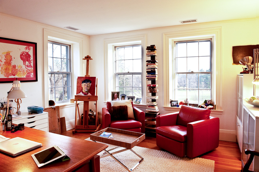 Inspiration for an eclectic home office in Boston with white walls and medium hardwood floors.