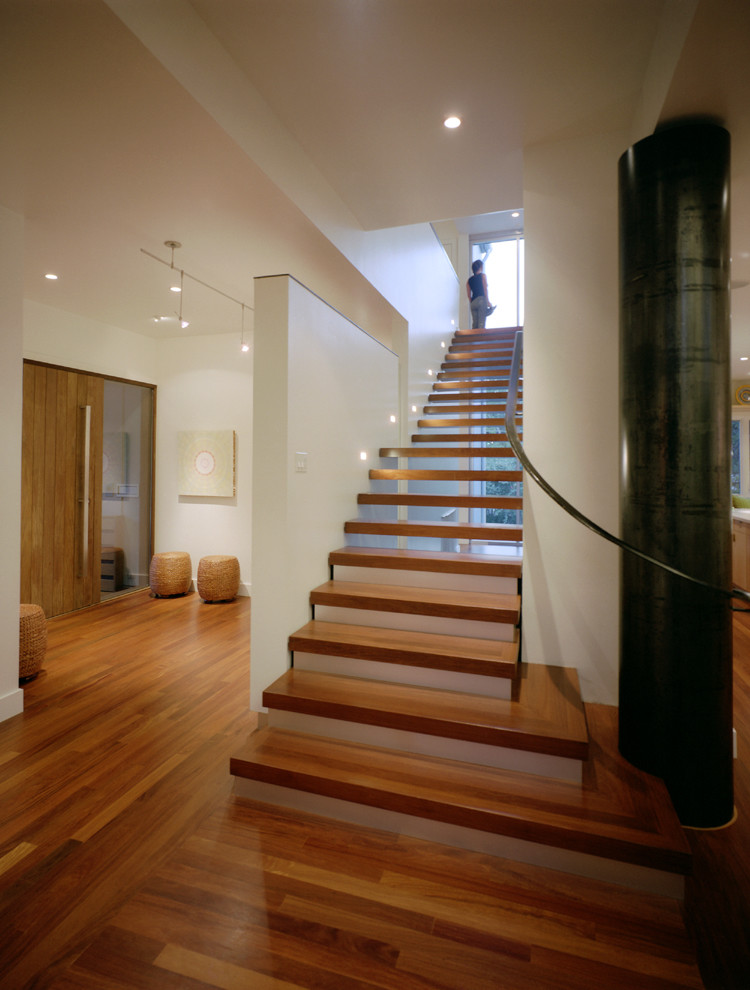 This is an example of a contemporary wood staircase in Austin with open risers.