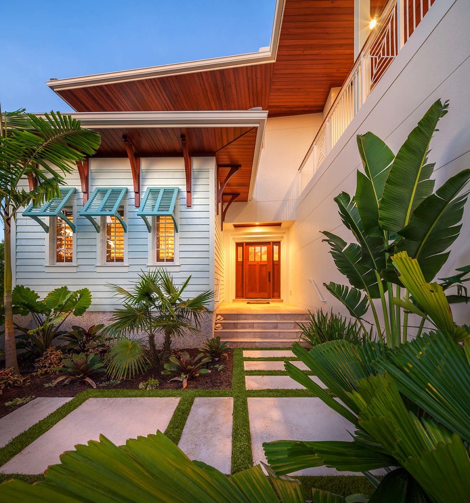 Inspiration for a tropical white exterior in Tampa.