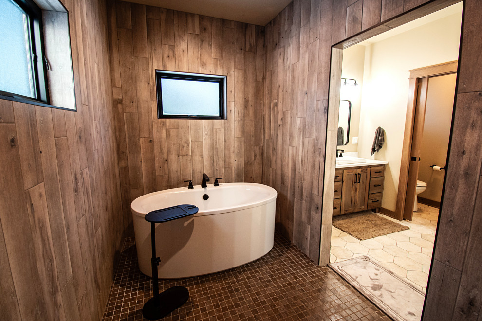 Large mountain style master multicolored tile and ceramic tile ceramic tile, multicolored floor and single-sink freestanding bathtub photo with flat-panel cabinets, medium tone wood cabinets, a two-piece toilet, beige walls, a drop-in sink, quartzite countertops, multicolored countertops and a freestanding vanity
