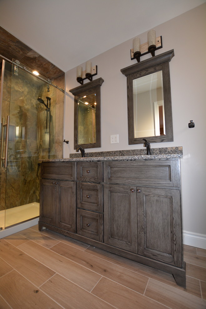Example of a mid-sized transitional 3/4 multicolored tile and porcelain tile porcelain tile alcove shower design in Toronto with shaker cabinets, distressed cabinets, a one-piece toilet, gray walls, an undermount sink and granite countertops
