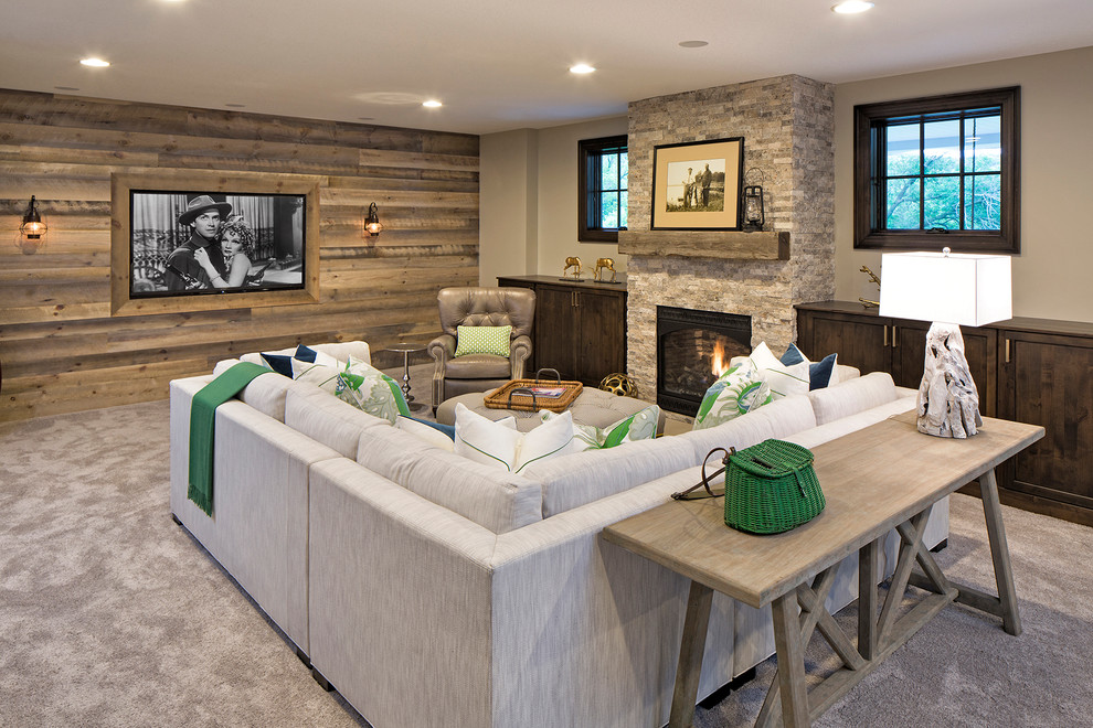 Photo of a beach style basement in Minneapolis with beige walls, carpet, a standard fireplace and a stone fireplace surround.
