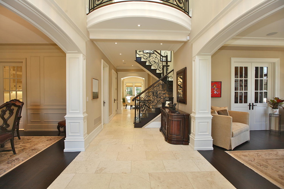 This is an example of a mid-sized mediterranean foyer in Toronto with beige walls, ceramic floors and beige floor.