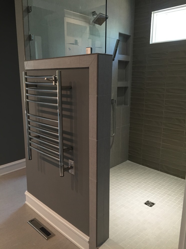Mid-sized contemporary master bathroom in Raleigh with an open shower, gray tile, glass tile, grey walls, ceramic floors, shaker cabinets, grey cabinets, granite benchtops, an open shower, a two-piece toilet, an undermount sink and grey floor.