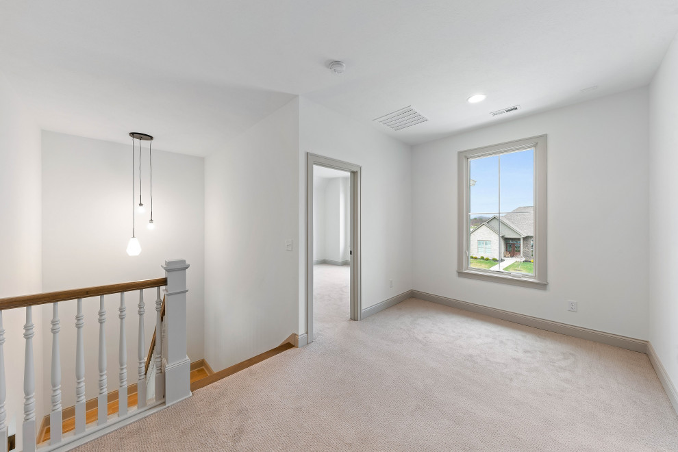 Example of a large transitional vinyl floor and beige floor hallway design in Indianapolis with white walls