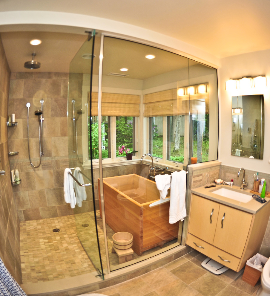 Design ideas for an expansive contemporary master bathroom in Boston with a japanese tub, a double shower, multi-coloured tile, an undermount sink, light wood cabinets, wood benchtops and stone tile.