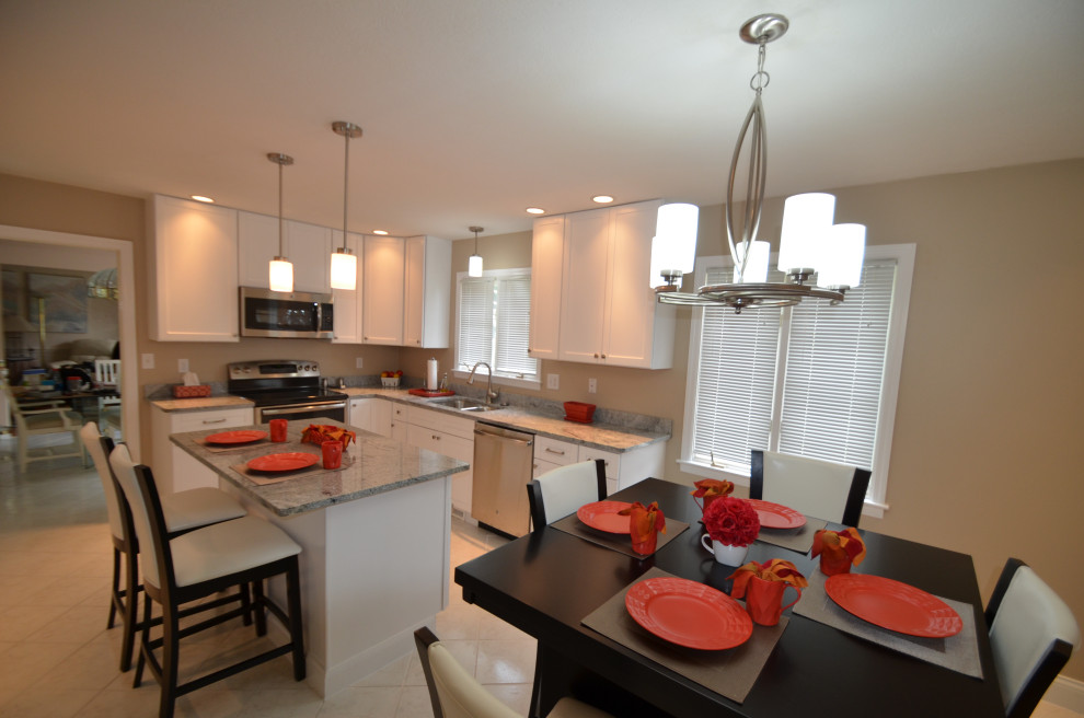 Inspiration for a mid-sized transitional u-shaped porcelain tile and beige floor eat-in kitchen remodel with an undermount sink, raised-panel cabinets, beige cabinets, granite countertops, stainless steel appliances, an island and multicolored countertops