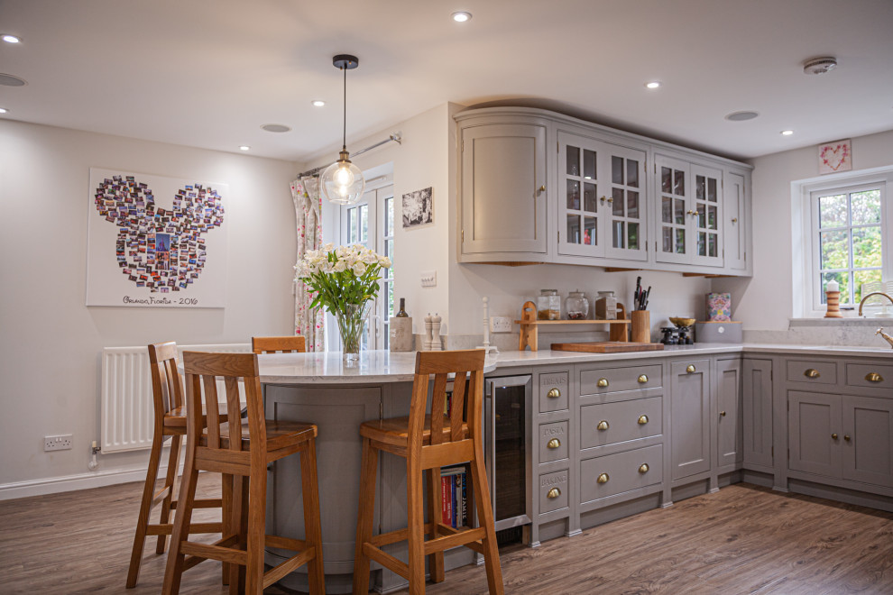 Photo of a mid-sized traditional u-shaped eat-in kitchen in Surrey with beaded inset cabinets, grey cabinets, quartzite benchtops, no island and white benchtop.